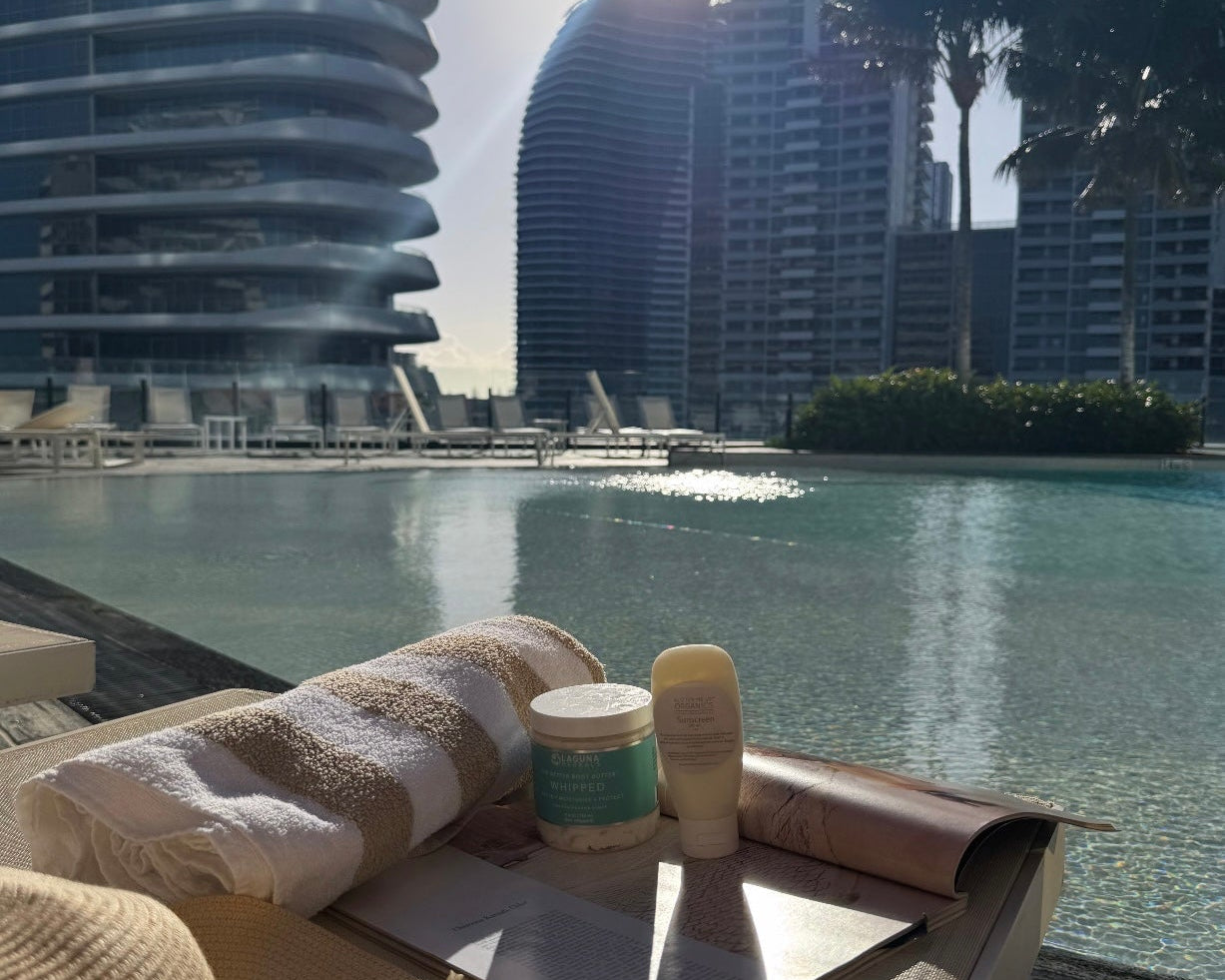 Sunscreen beach towel sun hat next to swimming pool summer aesthetic image