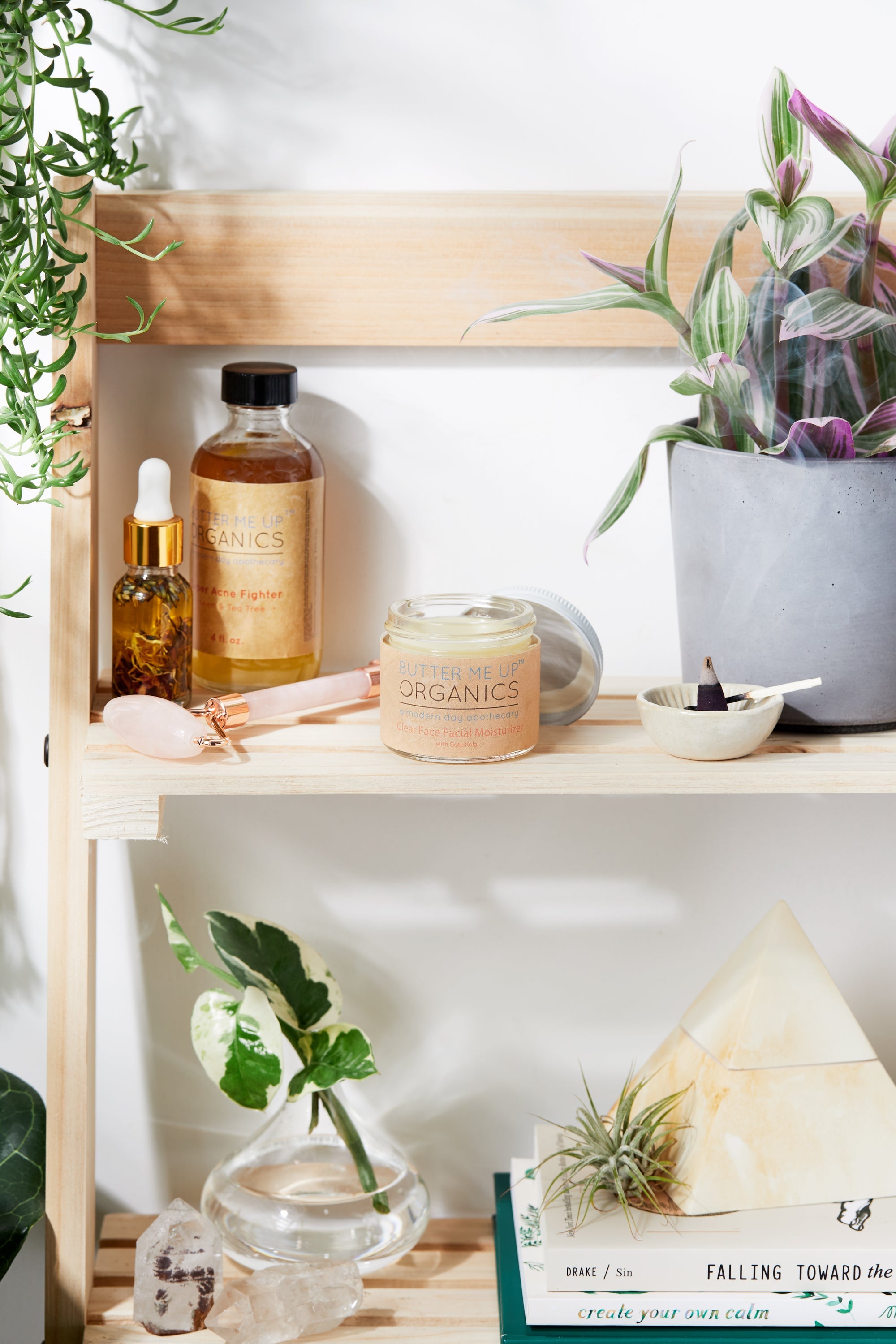 Organic Hydrating Facial Moisturizer with Aloe & Rosehip Oil opened product image in aesthetic shelf backdrop with rose quartz, green leaves, crystals and books