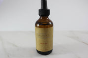 product Organic Hair Oil for Healthy, Shiny Hair in white minimalistic backdrop