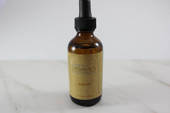 product Organic Hair Oil for Healthy, Shiny Hair in white minimalistic backdrop